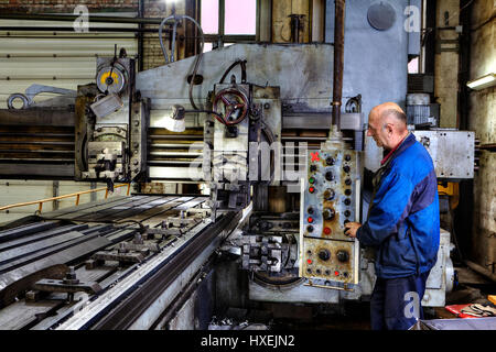 St. Petersburg, Russia - May 21, 2015: Machine tool operator planing and milling double column. Stock Photo