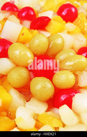Fruit salad texture. Fruits as background pattern. Exotic Fruits  Fruit salad with cocktail cherry sour cherry mango pineapple grapes,pear Stock Photo