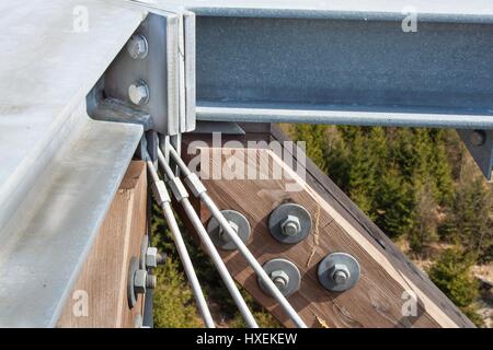 Wooden beams with screws in the structure. Assembling and connecting wooden beams. Detail of building connections. The construction of the observation Stock Photo