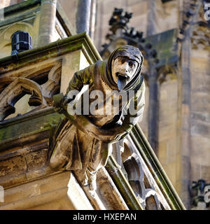 Human-like grotesque gargoyle on the walls of Saint Vitus Cathedral in Prague, Czech Republic. Stock Photo