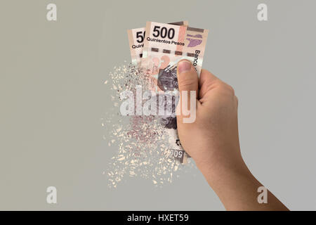 Two five hundred Mexican Pesos bills pulverize in a man's hand Stock Photo