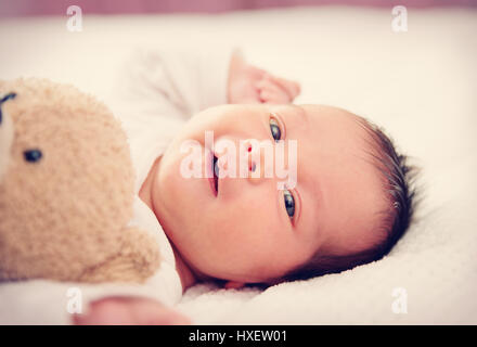 Cute newborn baby girl lying in the bed Stock Photo