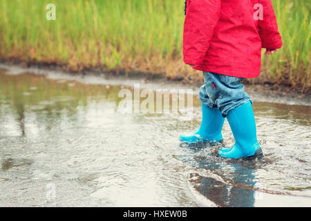 Red raincoat, green wellies Stock Photo - Alamy