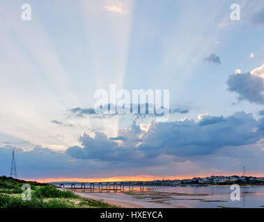 Beautiful rays of light protruding from clouds above Phillip Island Bridge at sunrise. Melbourne, Victoria, Australia Stock Photo