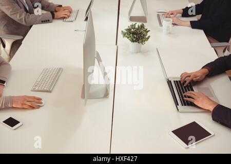 Group of executives working at desk in office Stock Photo