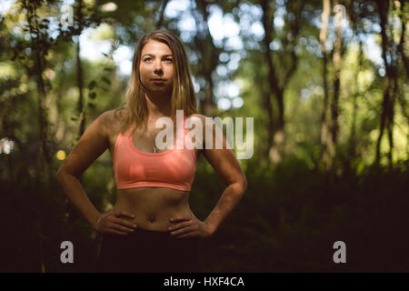 Beautiful woman exercising in the forest Stock Photo