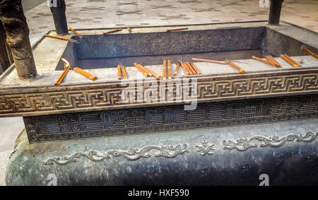 Incense burning on a copper censer - Buddhist Temple - Shanghai, China Stock Photo