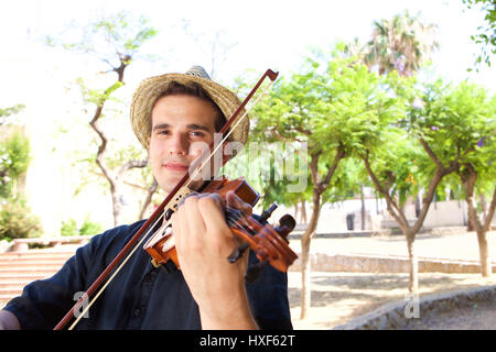 Portrait of a man playing violin outside Stock Photo