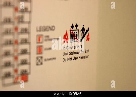 Fire Escape Route placque in a hotel room. In case of Fire Use Stairway for Exit. Do Not Use Elevator Stock Photo