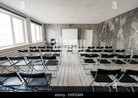 Empty modern classroom with black chairs projector screen Stock Photo