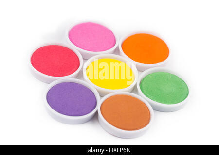 low angle view closeup of water color palette in white plastic containers isolated on white arranged in flower shape Stock Photo