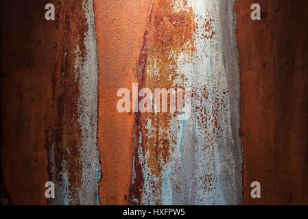 Grungy metal or concrete wall background with rusty stains and darkened sides Stock Photo