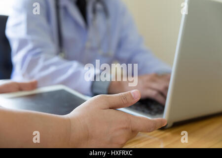 Medical technology network team meeting concept. Doctor hand working with modern digital tablet and laptop computer Stock Photo