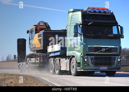 SALO, FINLAND - MARCH 19, 2017: Green Volvo FH16 of Kuljetus Nurmela transports Volvo EC300E Crawler excavator on gooseneck trailer along highway on a Stock Photo