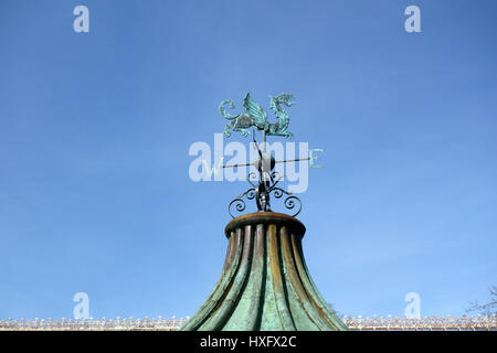 Old weather vane with dragon shape and blue sky Stock Photo