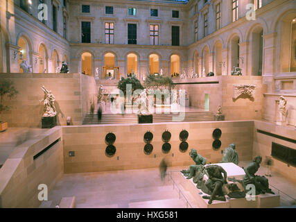 The Cour Puget of Richelieu Wing of the Louvre Museum.The Group of sculpture'The Four Captives'(Four Defeated Nations) in the foreground.Paris,2013 Stock Photo