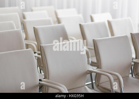 background of row of white seats. Empty chairs in the conference hall Stock Photo