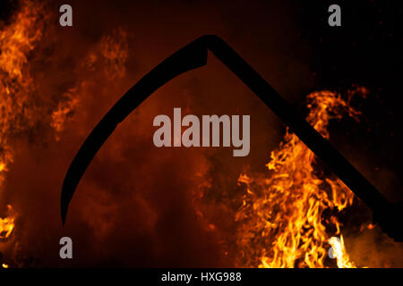 Death with a scythe on the background of fire,kills, war, disasters, revolutions Stock Photo