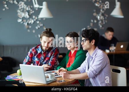 Modern designers reading online data necessary for their new project Stock Photo