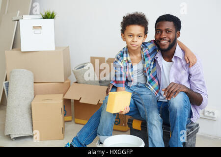 Happy boy with sponge and his father cleaning flat Stock Photo