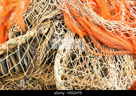 Pile of commercial fishing nets, with white floats, on the