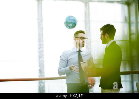 Economist giving advice to colleague during coffee-break Stock Photo