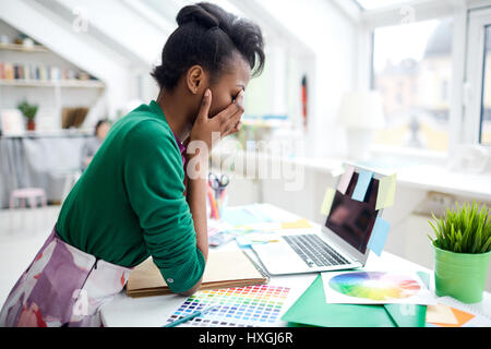 Stressed fashion-designer thinking over new project Stock Photo