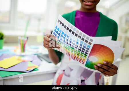 Swatch and diagram color palettes in hands of female Stock Photo