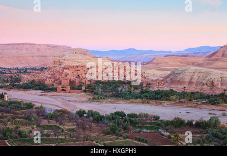 Ksar of Ait-Ben-Haddou and surroundings at dawn, Morocco.    Ait-Ben-Haddou along the bank of a parched river. Stock Photo