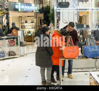 Shoppers inspect Coach handbags in the Macy's Herald Square flagship store on Sunday, March 26, 2017. (© Richard B. Levine) Stock Photo