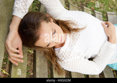 Portrait of a beautiful woman lying down on hammock outdoors Stock Photo
