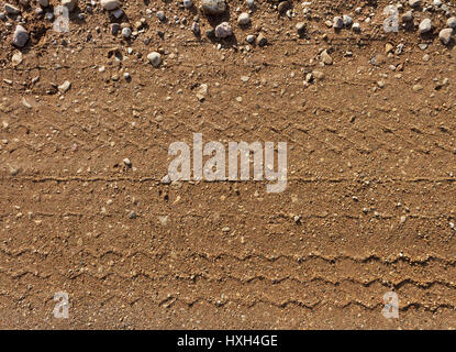 Gravel road surface with a print of a plurality of wheels. Stock Photo