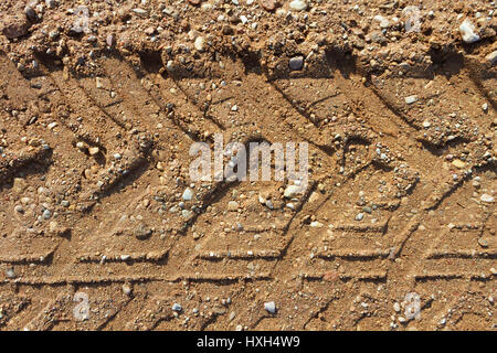 Gravel road surface with a print of a plurality of wheels. Stock Photo