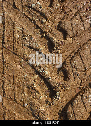 Gravel road surface with a print of a plurality of wheels. Stock Photo