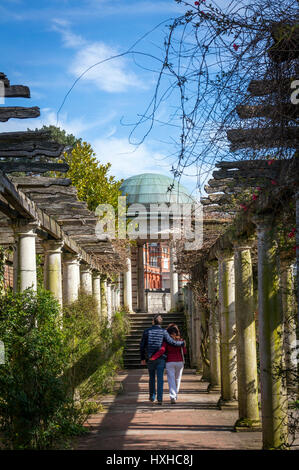 A couple walking through Hampstead Pergola & Hill Gardens on Hampstead Heath, London, UK Stock Photo