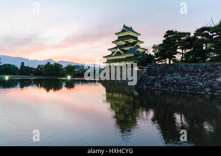 Matsumoto castle and sunset sky reflect on water at nagano japan Stock Photo