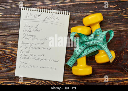 Notebook and measuring tape. Stock Photo