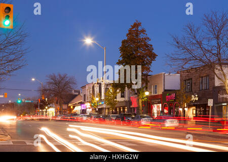 Storefronts and Lakeshore Road at dusk in downtown Port Credit, Mississauga, Ontario, Canada. Stock Photo