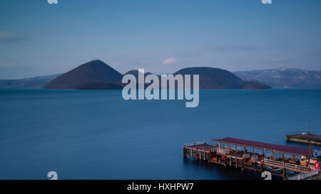 eyot and dock in theToya volcanic Lake Hokaidot Japan Stock Photo