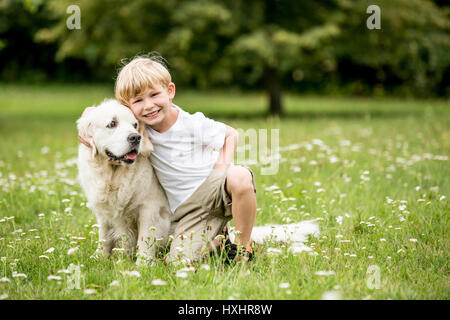 Happy boy and dog as friends as love your pet concept Stock Photo