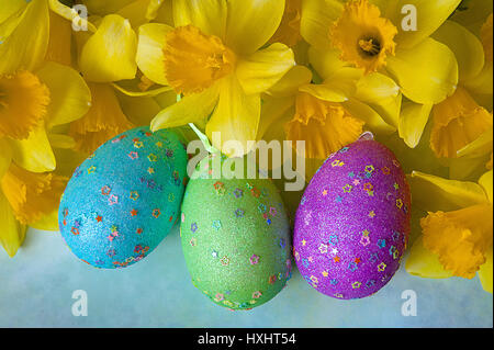 Daffodils And Colorful Decorated Eggs On Sunny Meadow - Easter Holiday Background Stock Photo
