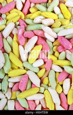 Candy from puffed rice grains. Sweet flavored puffed rice grains. Colorful snack. Stock Photo