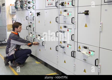 St. Petersburg, Russia - October 4, 2016: Electrical Engineer make Services, Testing and Maintenance Low voltage switchgear. Stock Photo