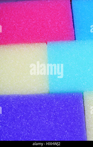 Cleaning kitchen sponge texture as background. Colorful yellow pink green purple blue multicolor sponges. Close up macro about sponges. Sponge pattern Stock Photo