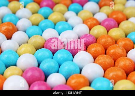 Bubble gum chewing gum texture. Rainbow multicolored gumballs chewing gums as background. Round sugar coated candy dragee bubblegum texture Stock Photo
