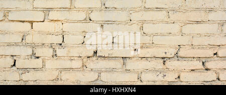 Panorama of old painted brick wall. Old bright brick wall texture. Brick wall painted in white Stock Photo