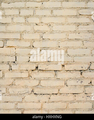 Background of old painted brick wall. Old bright brick wall texture. Brick wall painted in white Stock Photo