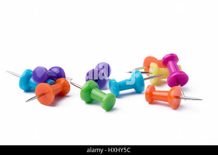 Multicolored pushpins on a white background. Stock Photo
