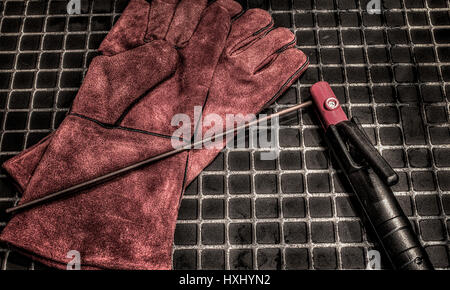 Gloves for welders.Orange leather gloves and electrodes for welding . Accessories of welder. Stock Photo
