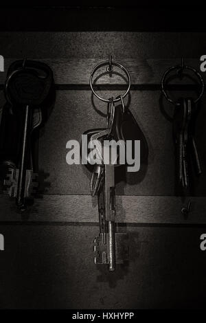 Car and house keys hanging on wall Stock Photo